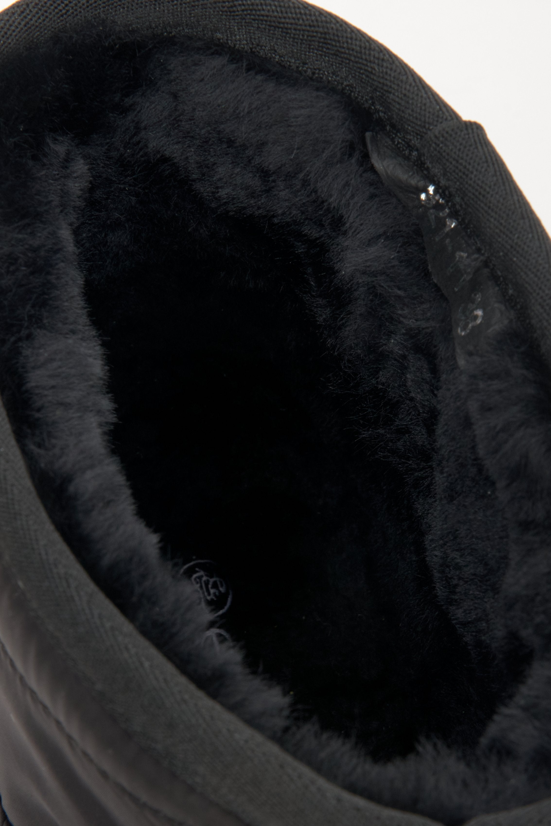 Women's black snow boots by Estro - close-up on the soft, fur-lined insert of the boot.