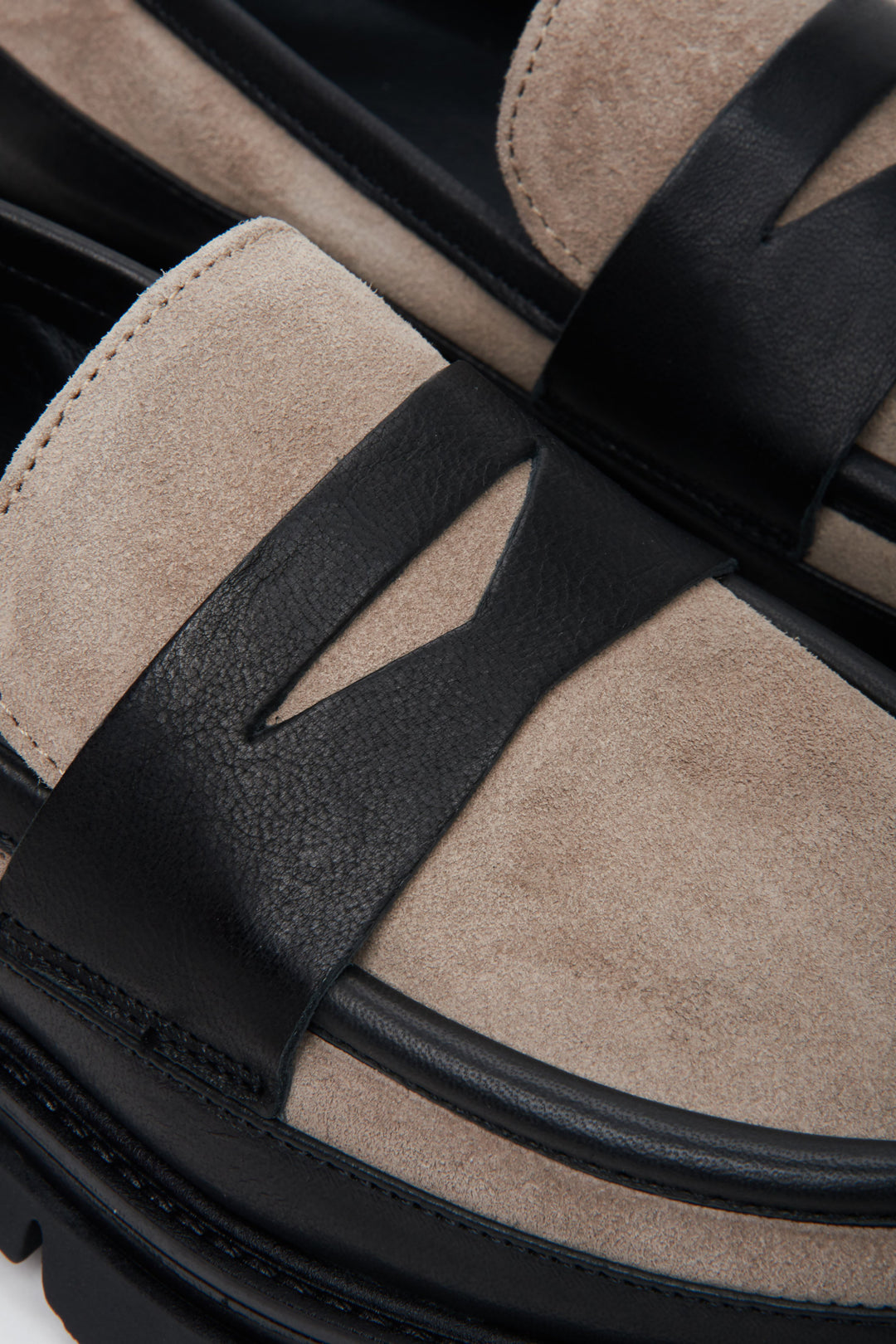 Women's slip-on penny loafers in black-and-beige - close-up on the details.