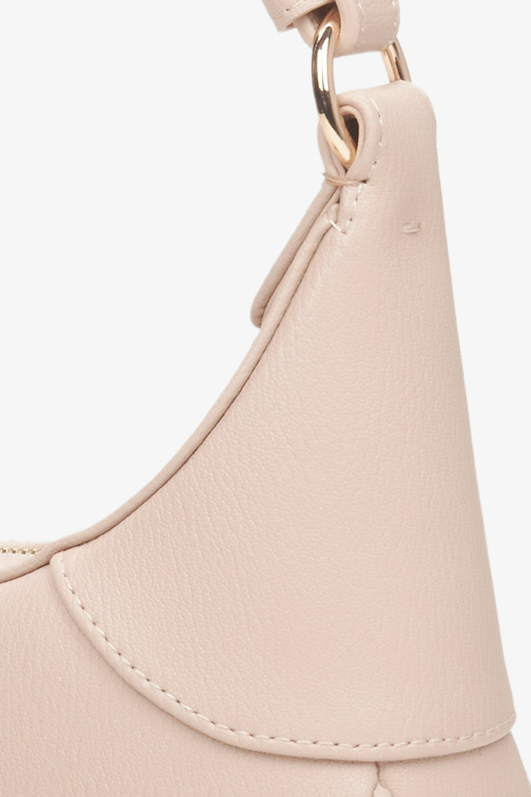 Women's pale pink leather handbag - a close-up on details.