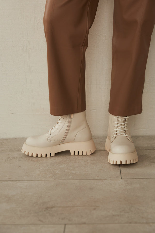 Women's beige leather boots by Estro - presentation on a model.