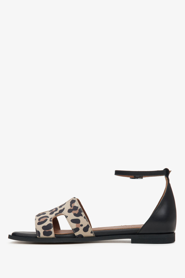 Women's black sandals with an animal print insert - side view.