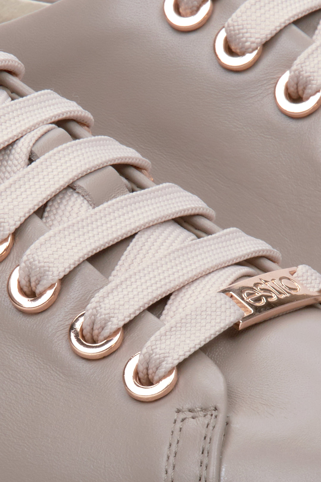 Women's beige Estro sneakers with laces made from genuine leather - close-up on the details.