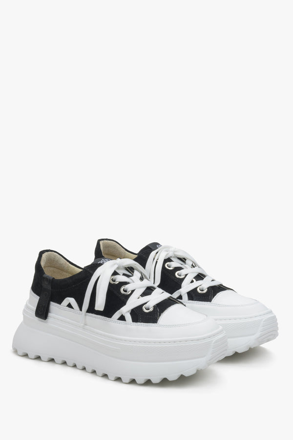 Women's white and black sneakers with perforated sole by Estro.