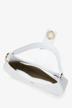 Interior presentation of a white leather women's handbag.