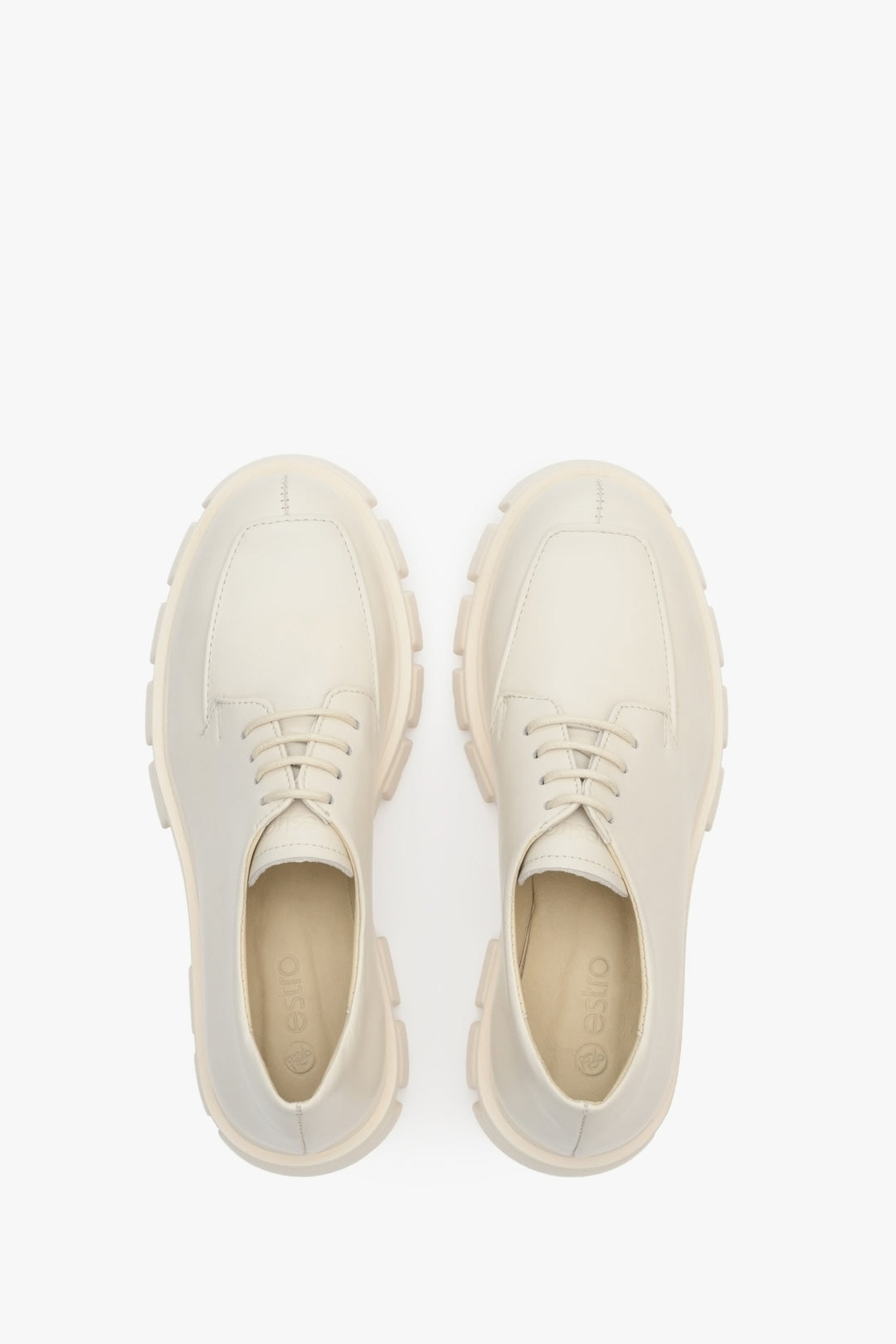 Lace-up women's leather shoes in beige - top view presentation of the footwear.