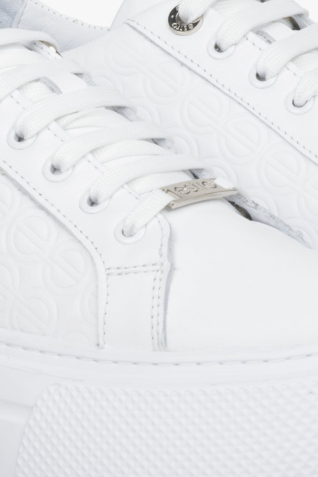 Women's white leather sneakers by Estro - close-up on the details.