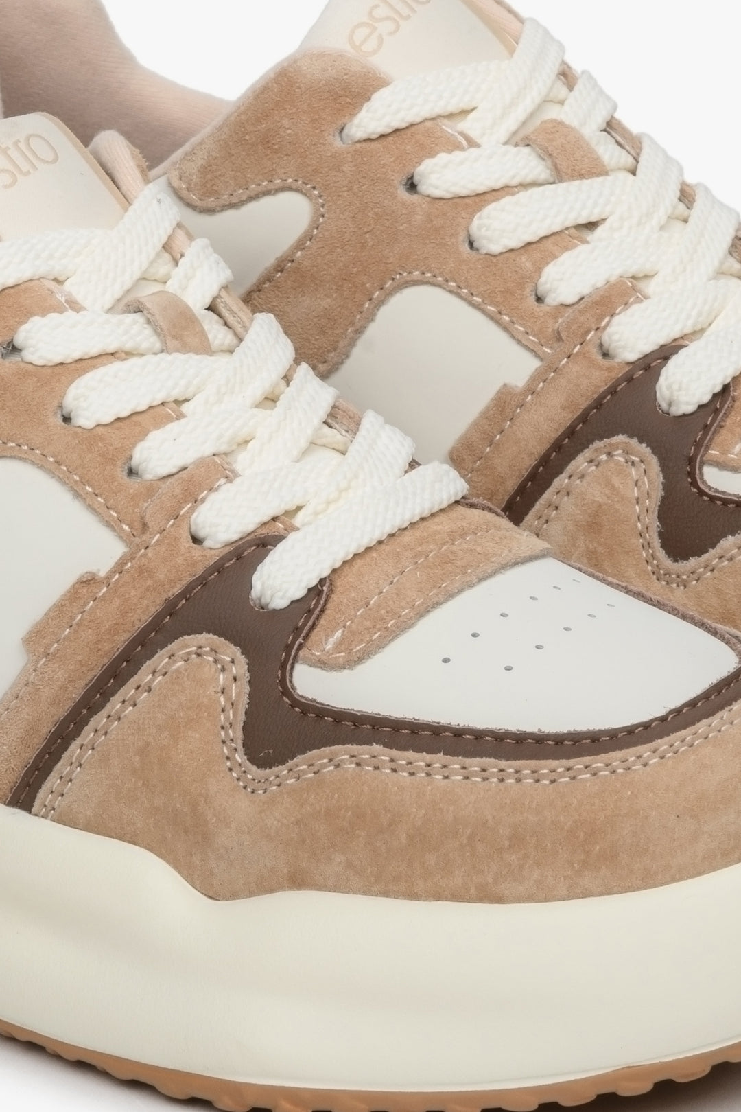 Women's beige and white sneakers - close-up on details.