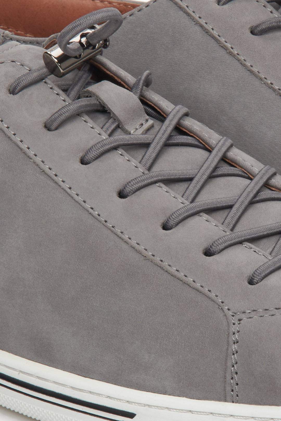 Grey Estro brand men's sneakers made of soft natural nubuck - close-up on the stitching and lacing system.