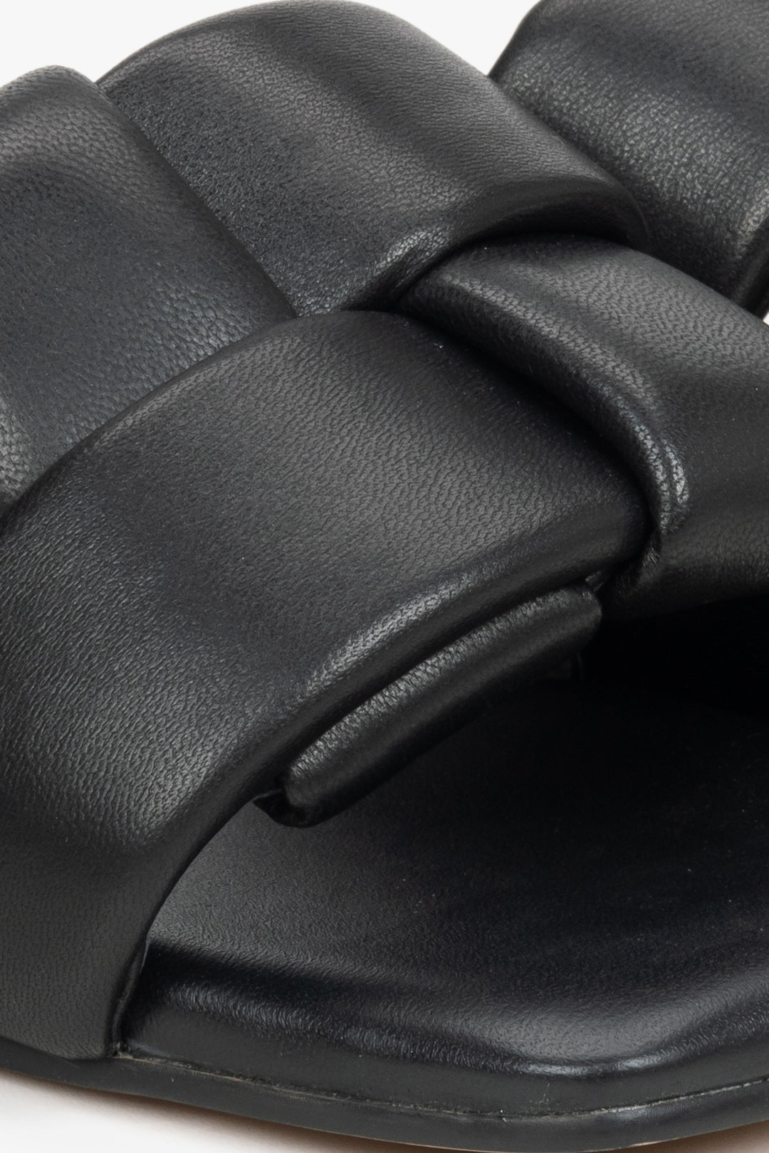 Women's black slides made of genuine leather by Estro - close-up on detail.