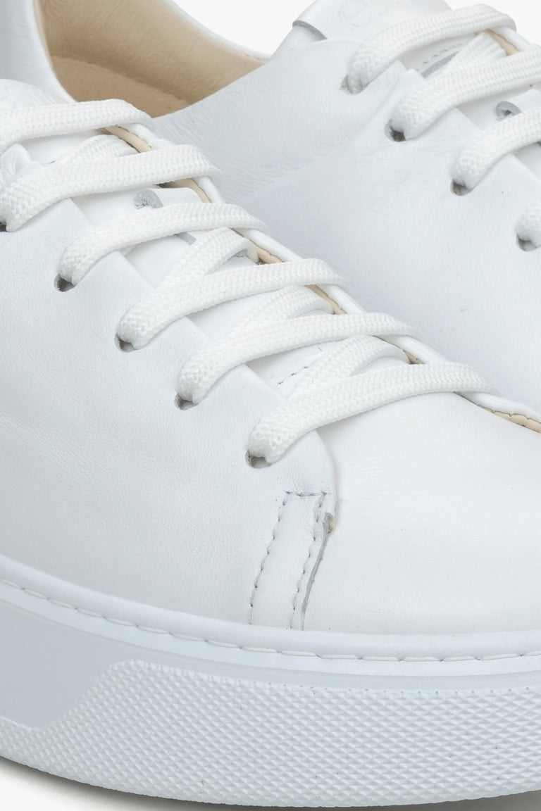 Close-up on details of white women's sneakers made of genuine leather Estro.