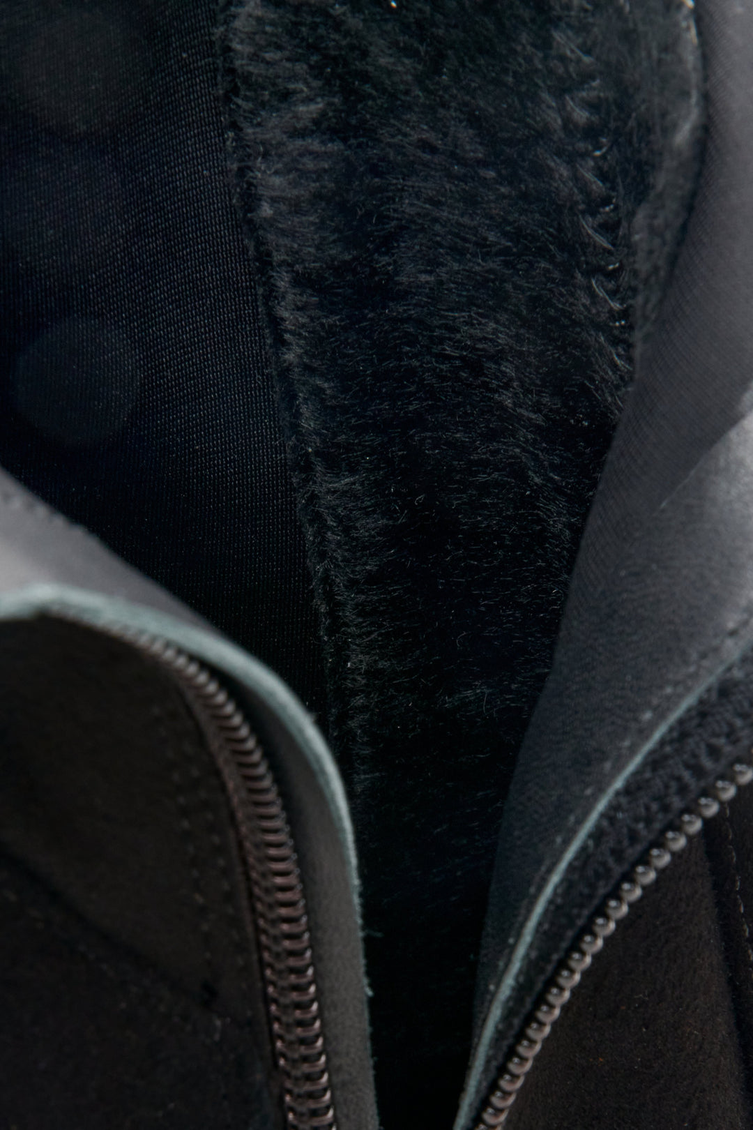 Women's black ankle boots with funnel heel made of genuine velour - close-up on the details.