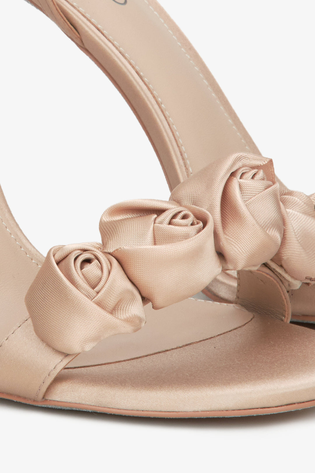 Women's beige high-heeled sandals - close-up on the ornament.