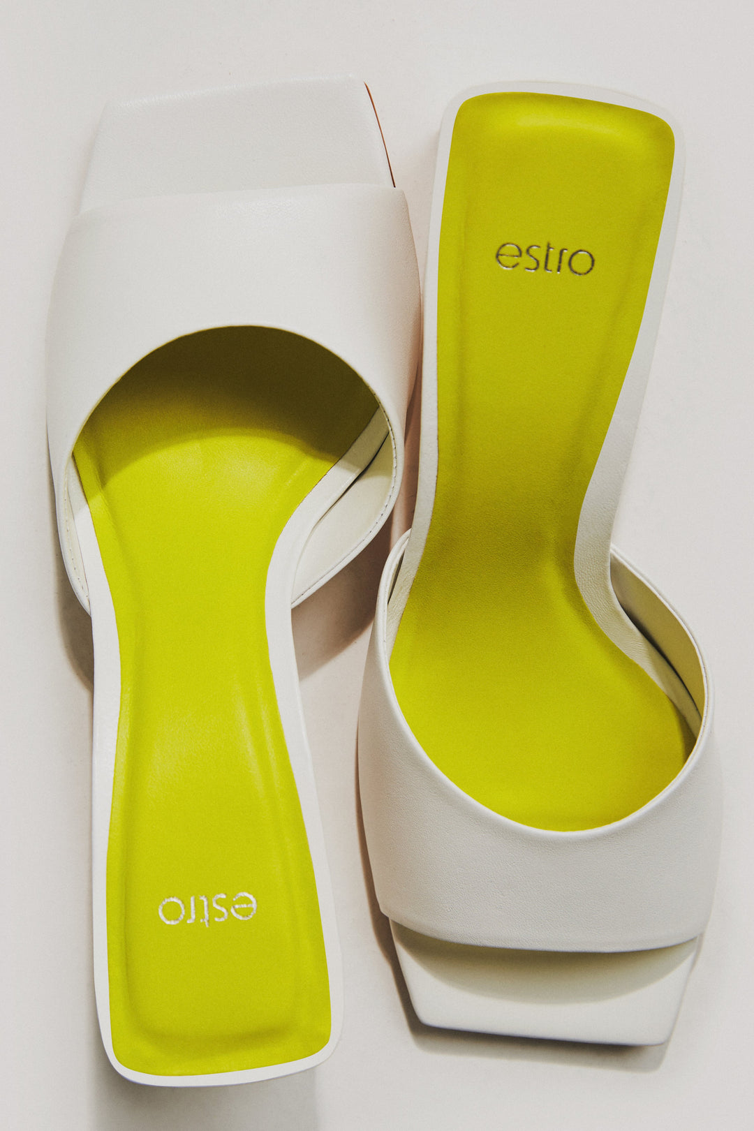 Women's white leather mules with a block heel by Estro.