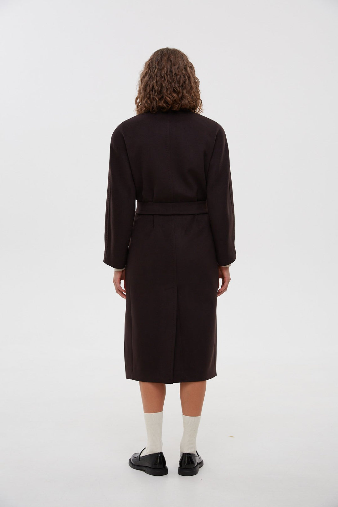 Women's black bucket coat with a belt - back of the model.