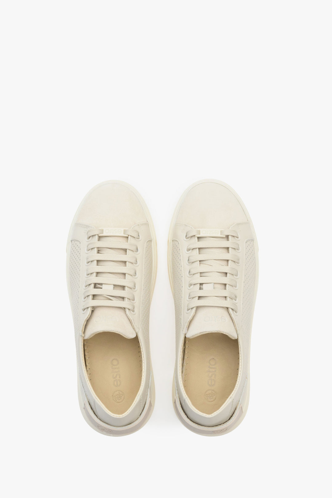 Women's beige leather sneakers with perforation - presentation of the footwear from above.