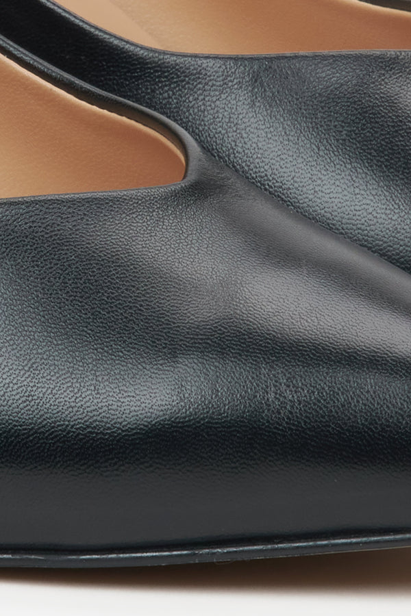 Women's black leather pumps - close-up on the detail.