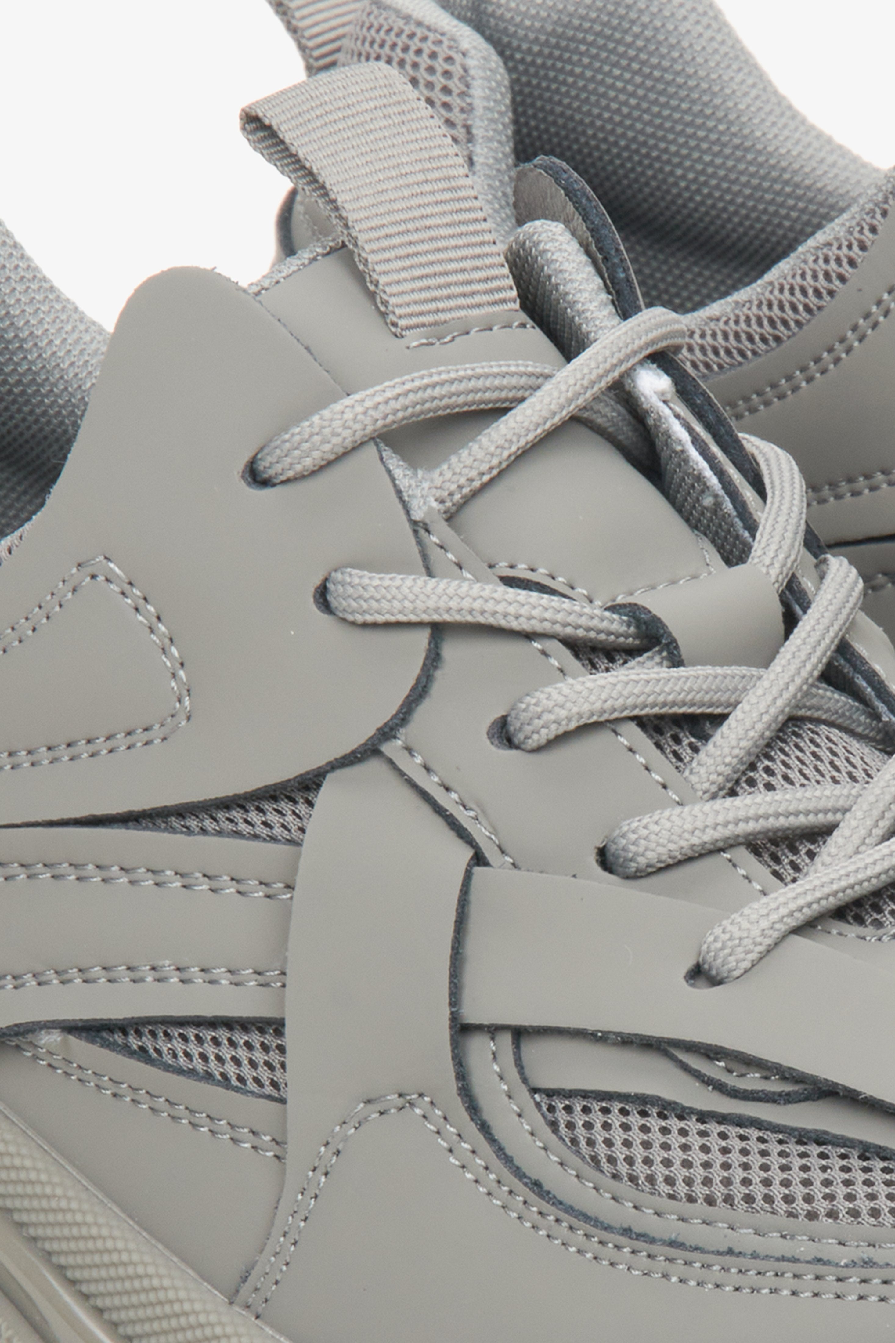 Women's grey sneakers made of genuine leather and textile material for spring and autumn - close-up of the lacing system.