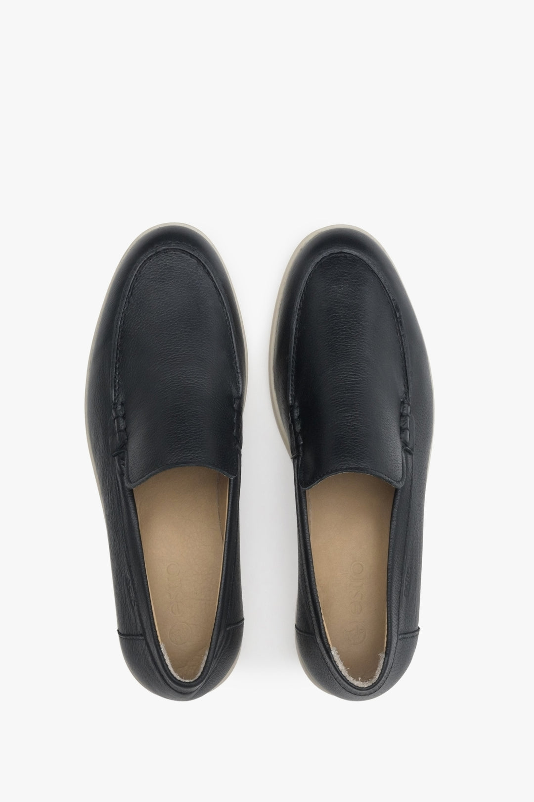 Women's black leather slip-ons - presentation of a shoe toe and sideline.