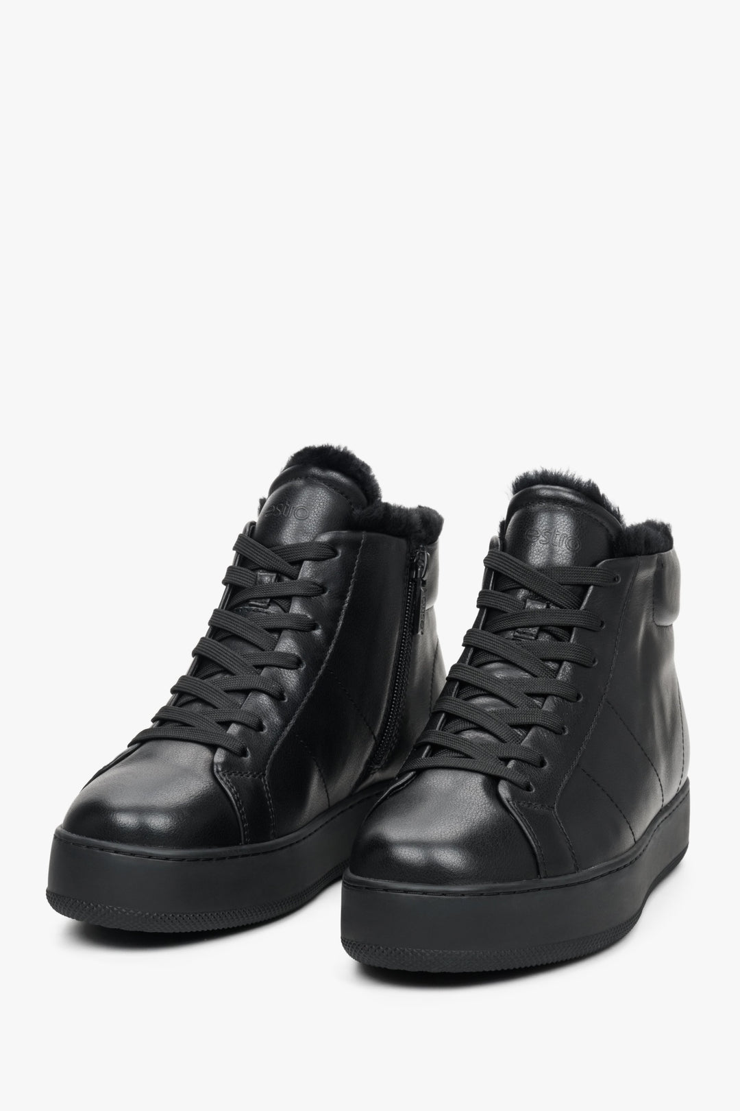 Women's black high-top sneakers made from genuine leather by Estro - close-up on the front of the shoe.