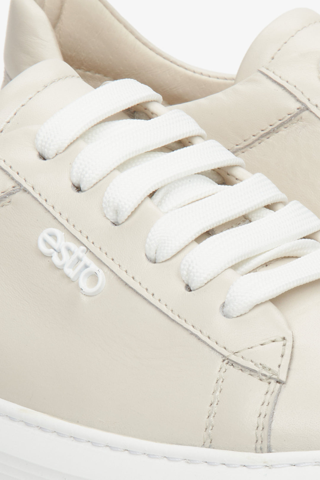 Women's light beige leather sneakers by Estro with laces - close-up on the details.