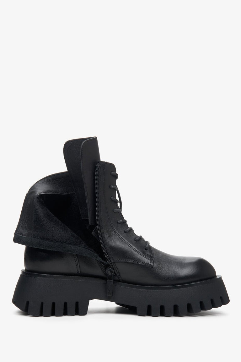 Women's winter boots made of genuine leather in black - close-up of the warm filling of the shoe.