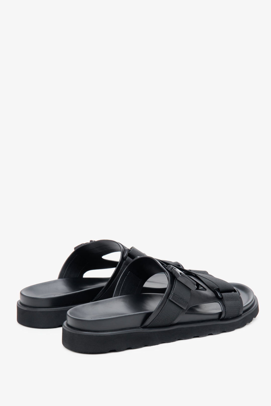Men's comfortable black slides in genuine leather and textiles - close-up of the side profile and heel.