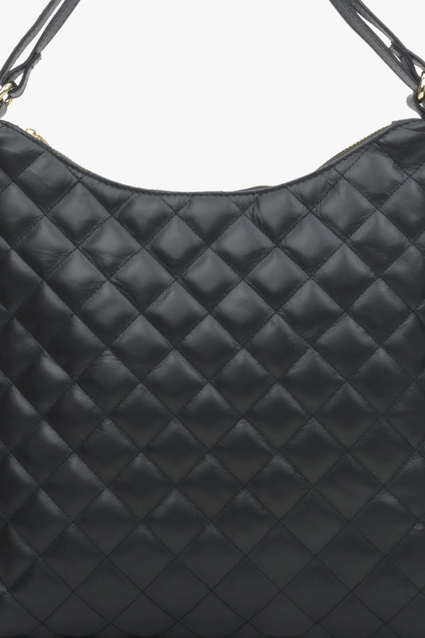 Women's black leather quilted handbag.