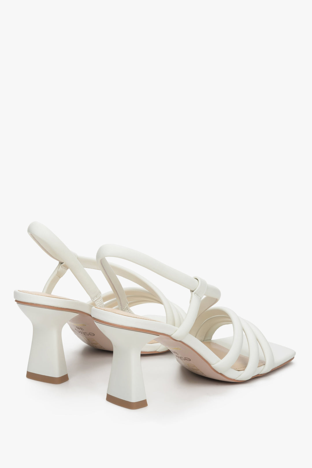 Women's light beige strappy sandals made of natural leather - a close-up on heel and shoe sideline.