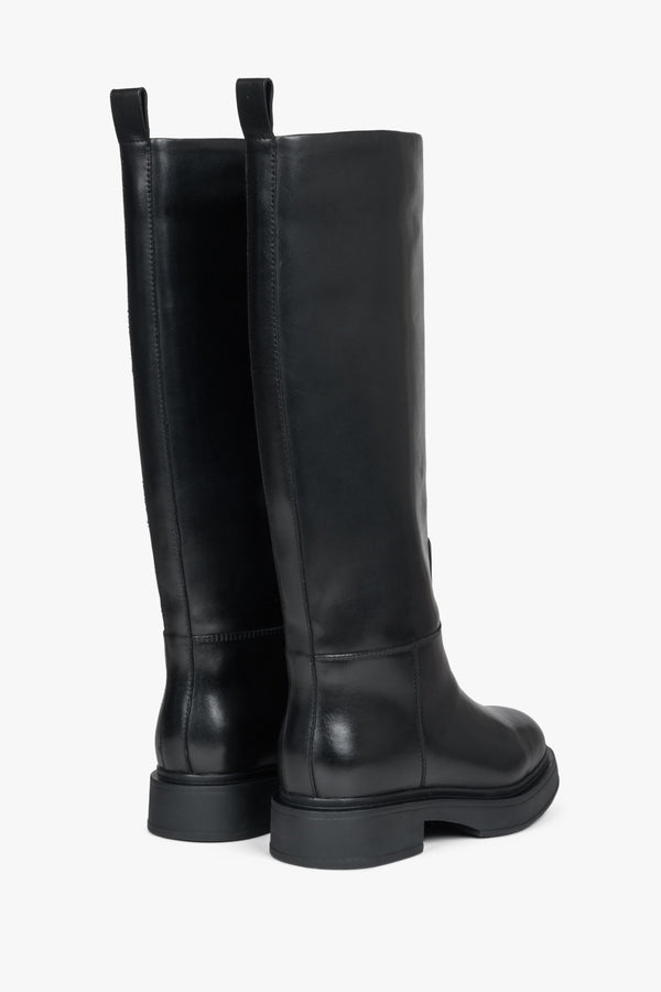 Elevated, black Estro women's leather boots with natural fur for winter.