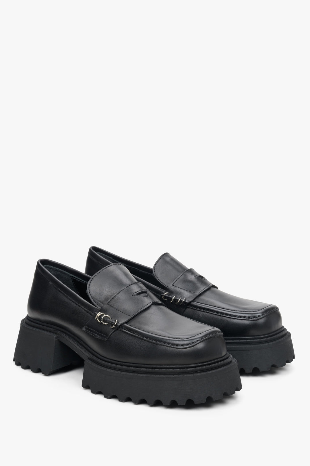 Women's black leather moccasins by Estro with embellishments.