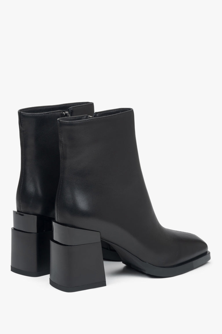 Women's black ankle boots made of genuine leather with a block heel and subtle insulation - back view of the model.