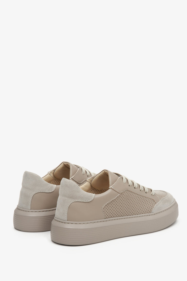 Women's beige sneakers made of genuine leather and suede - close-up on the heel.