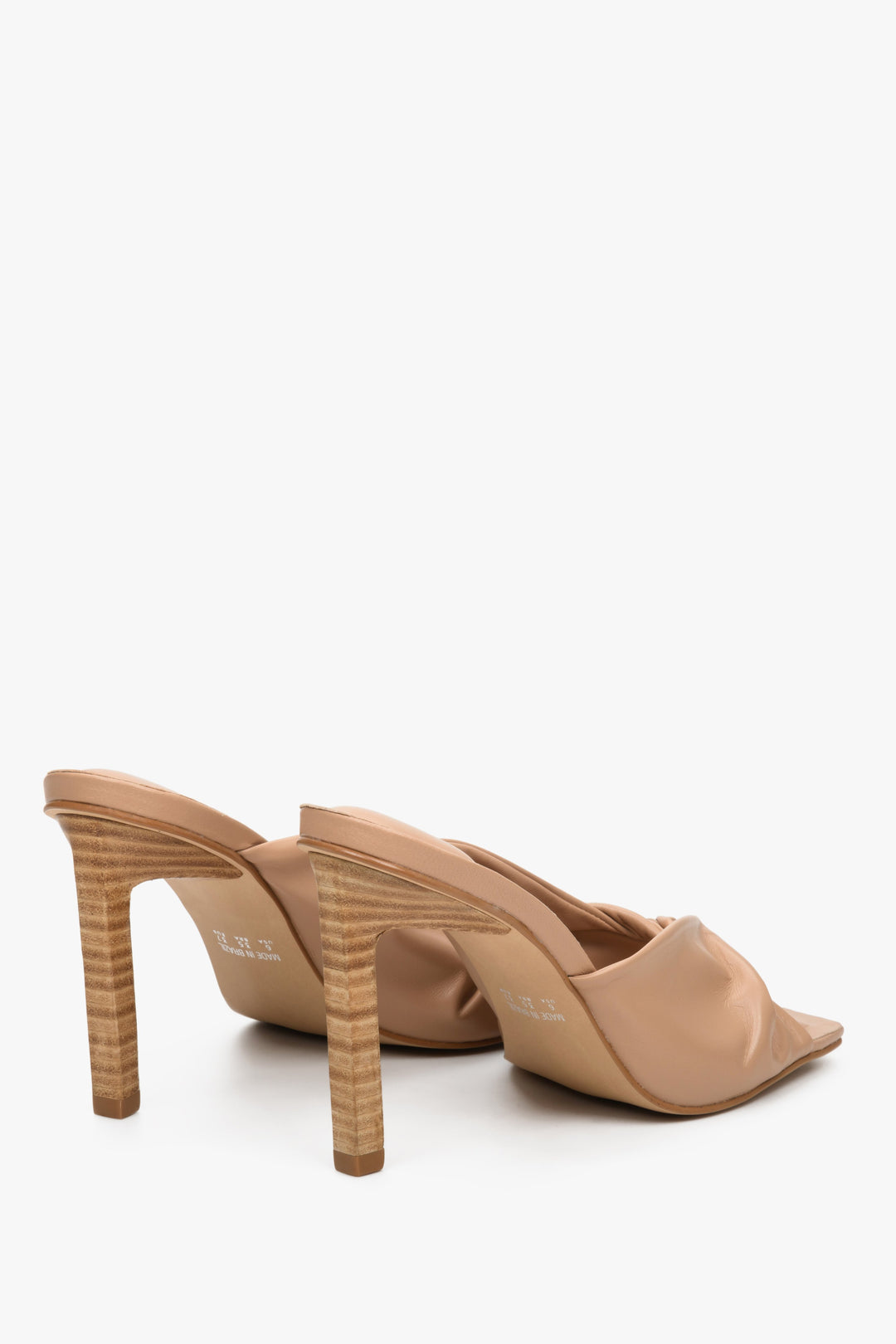 Women's beige leather high heel mules by Estro - close-up on the back of the shoes and the heel.