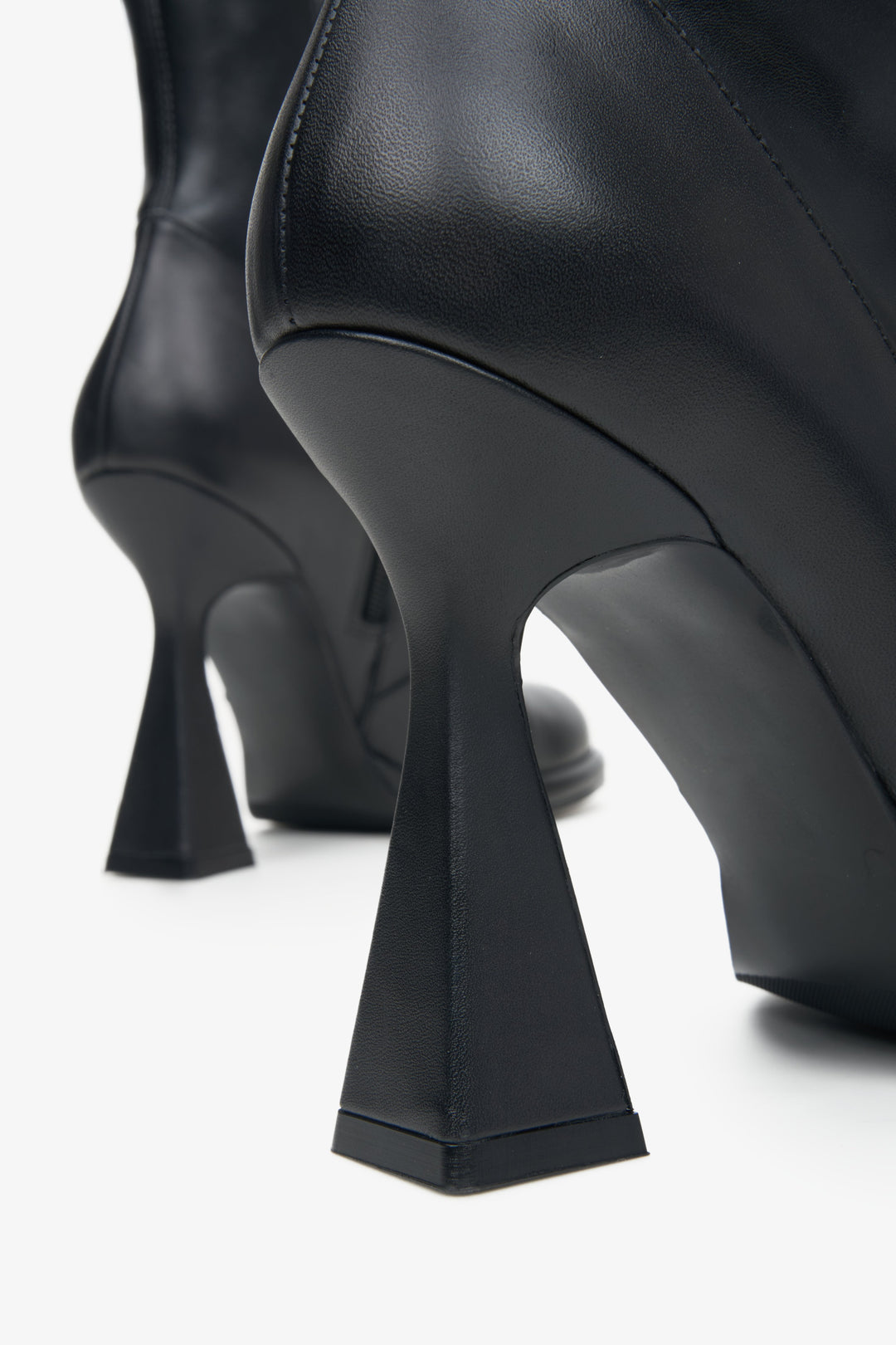 Women's black ankle boots with funnel heel made of genuine leather - a close-up on the heel.