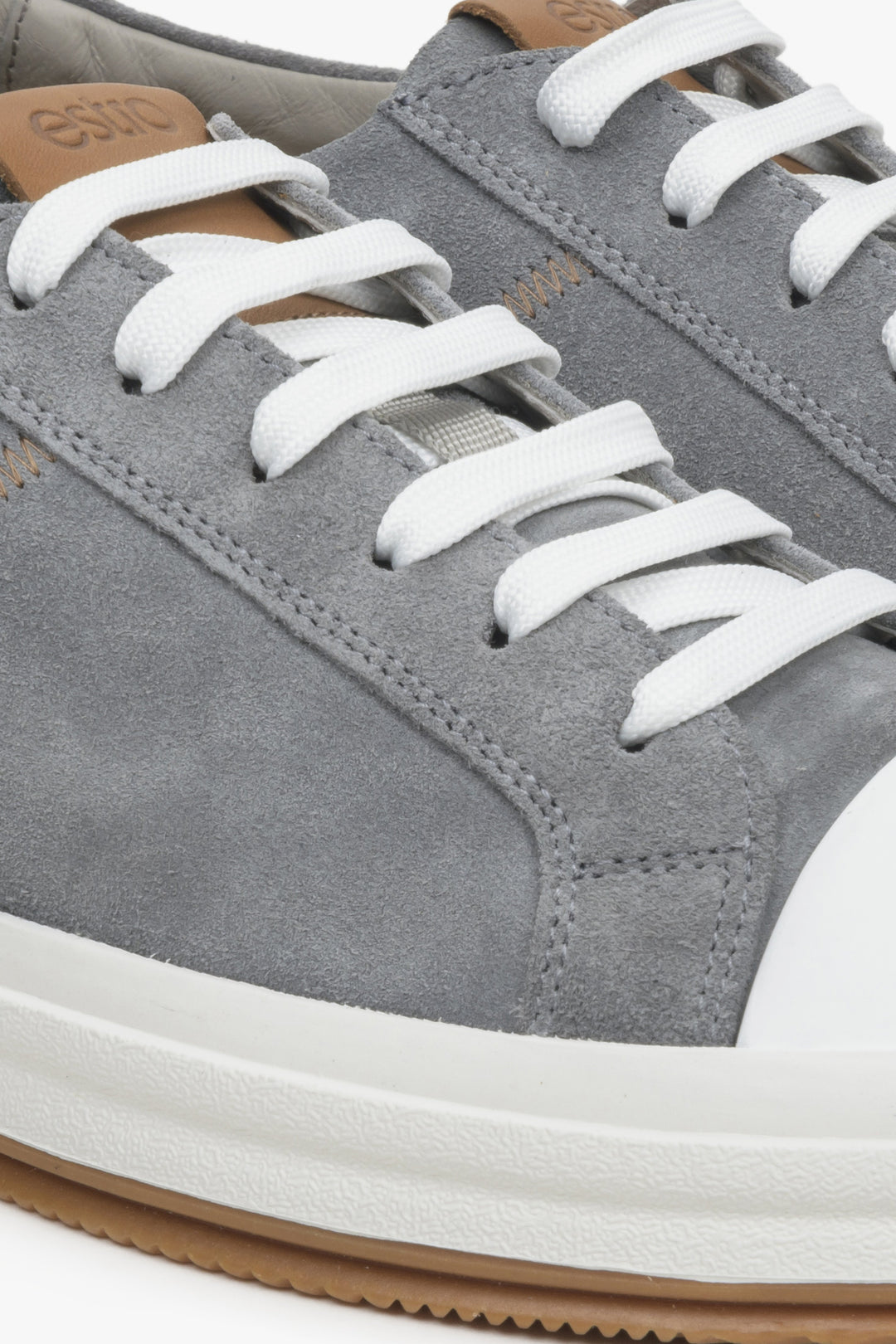 Men's grey sneakers made of genuine velour - close-up on details.