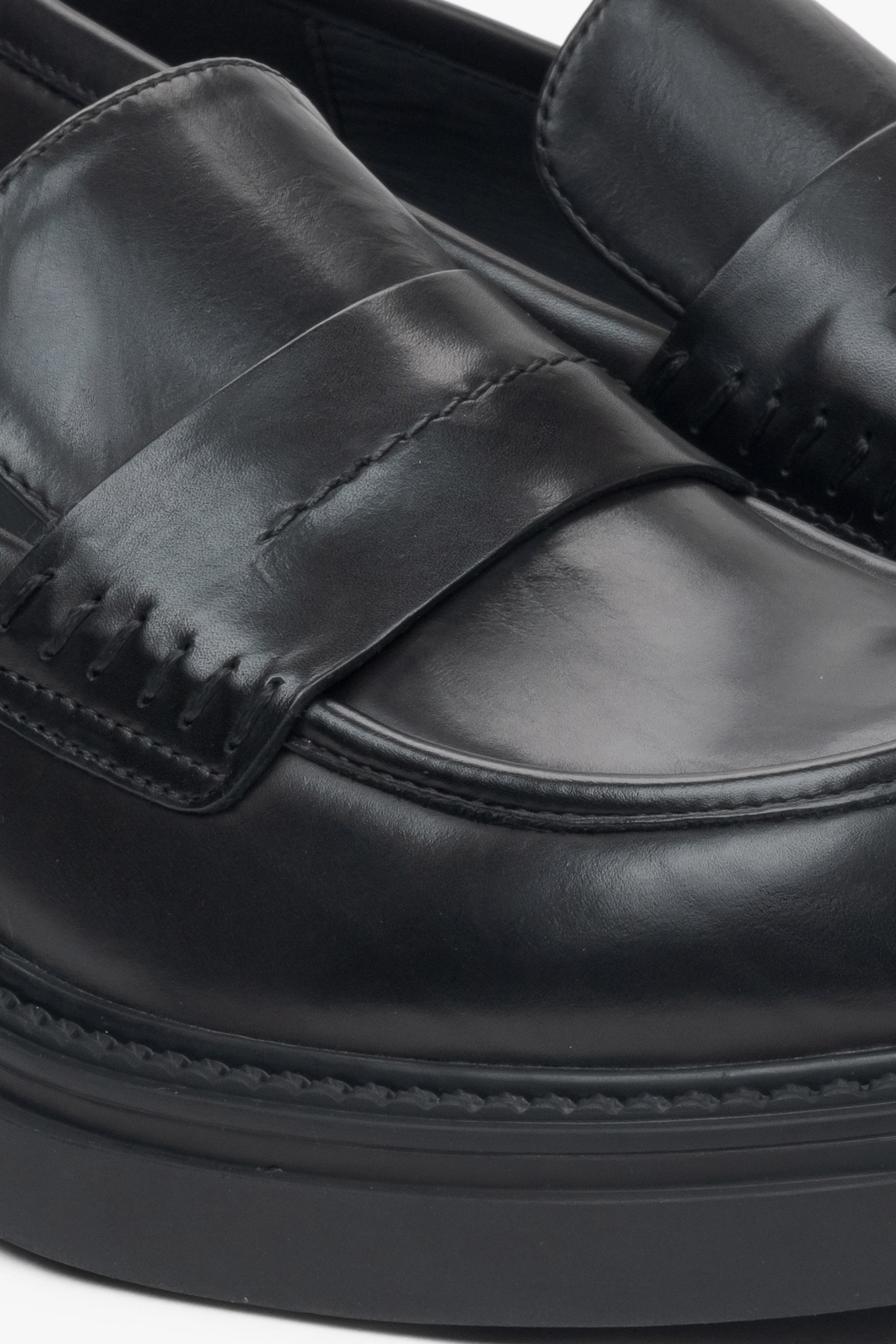 Elegant women's  black penny loafers with a square heel from Estro - close-up of the details.