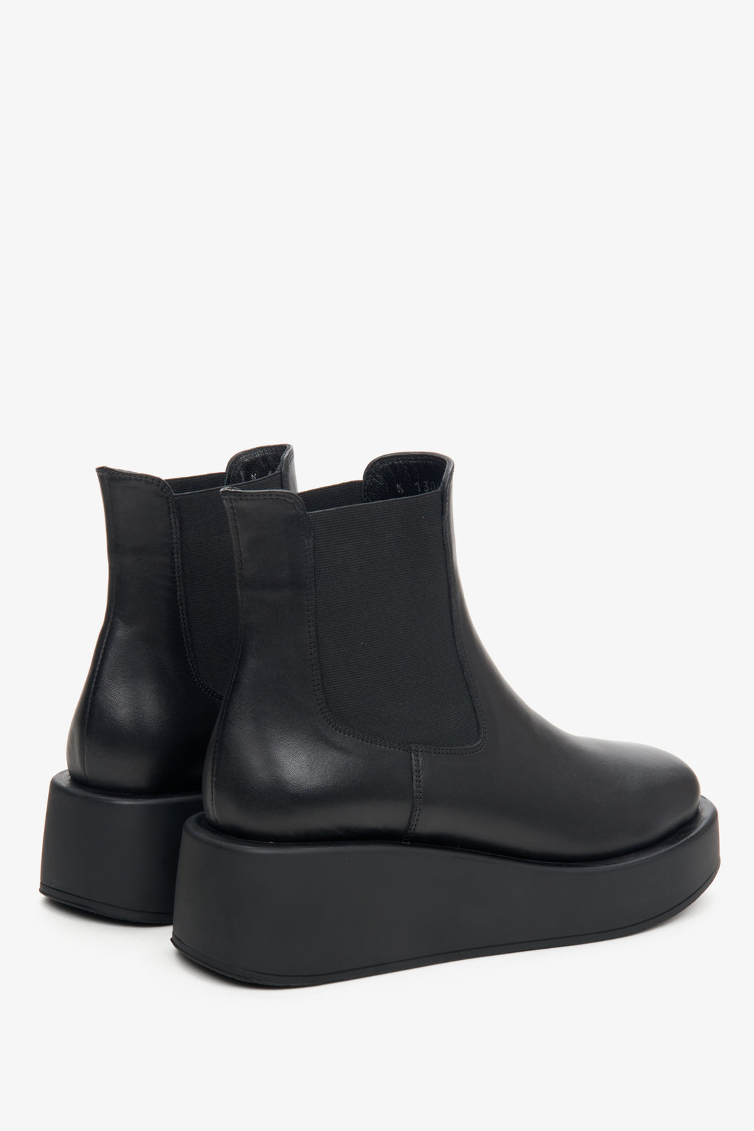 Women's black leather platform boots by Estro - close-up on the side line and heel counter.