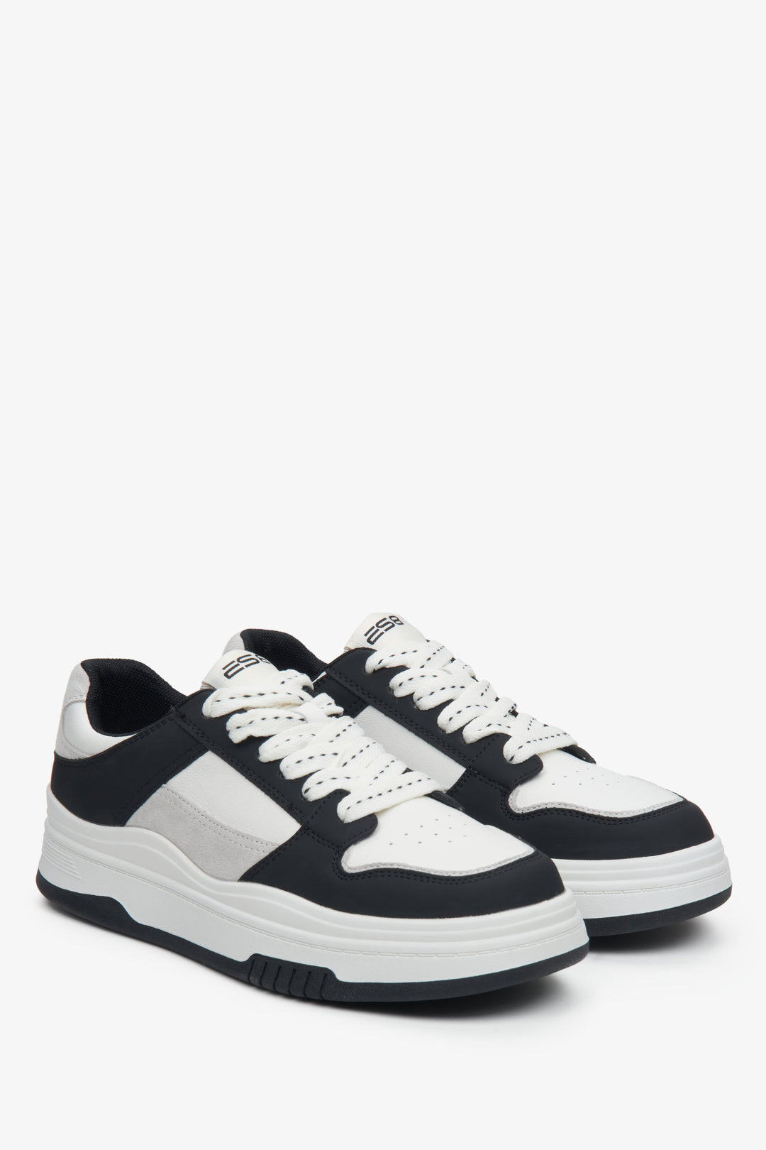 Women's white and black leather sneakers.