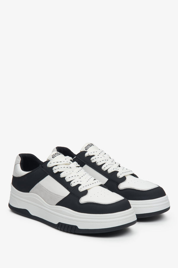 Women's white and black leather sneakers.