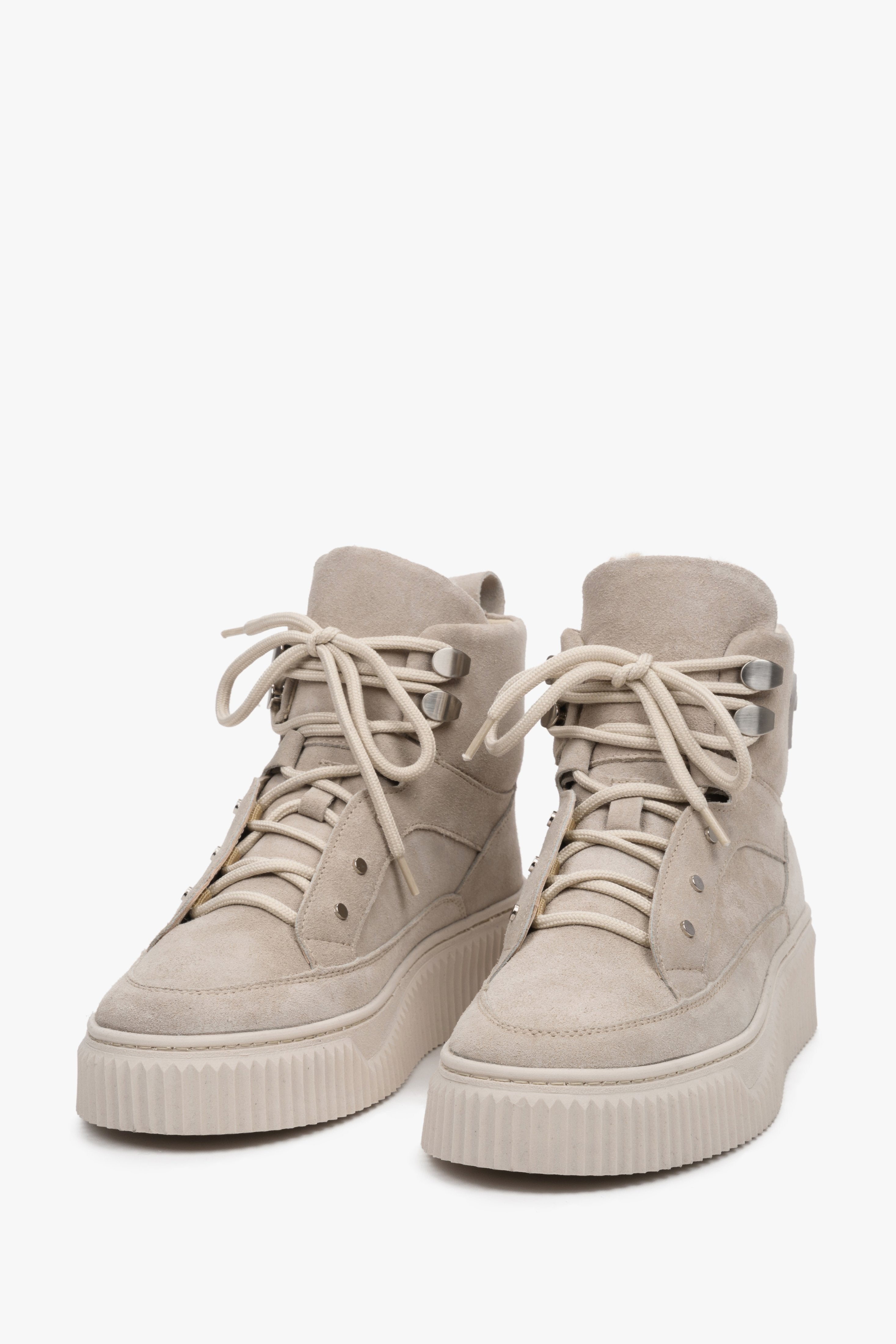 High-top women's winter sneakers in genuine beige suede with laces by Estro - close-up on the front of the shoe.