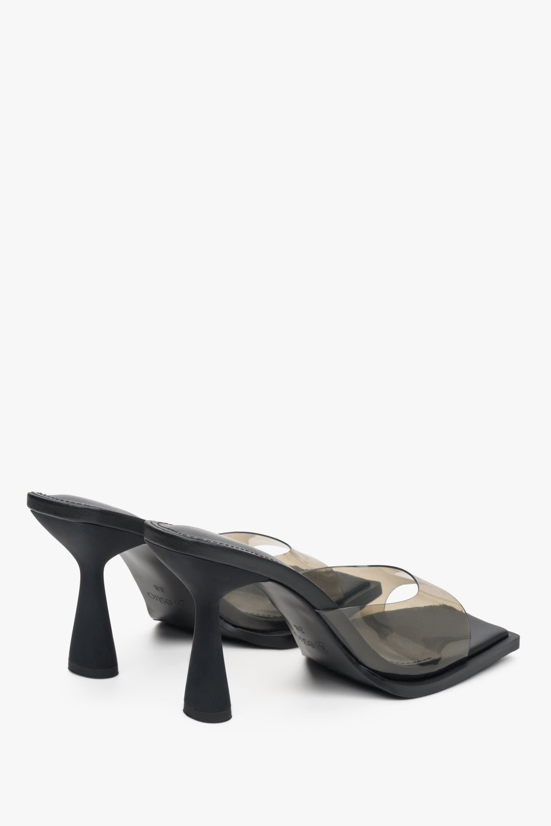 Estro women's clear high-heeled sandals with a black sole - close-up on the rear part of the footwear.