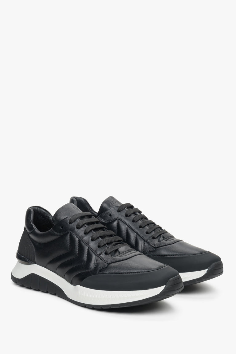 Men's black sneakers made of genuine leather with a white, flexible sole.