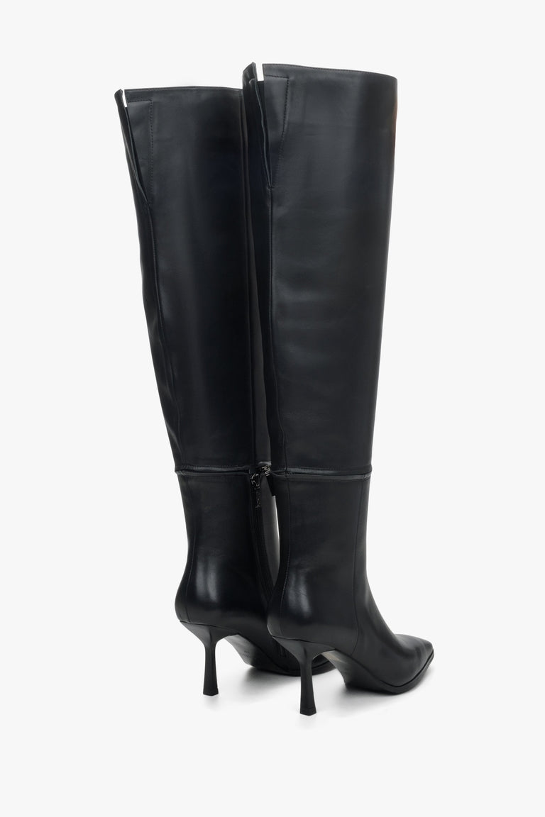 Women's black leather unfastened boots by Estro - close-up on the heel and side stripe of the shoes.