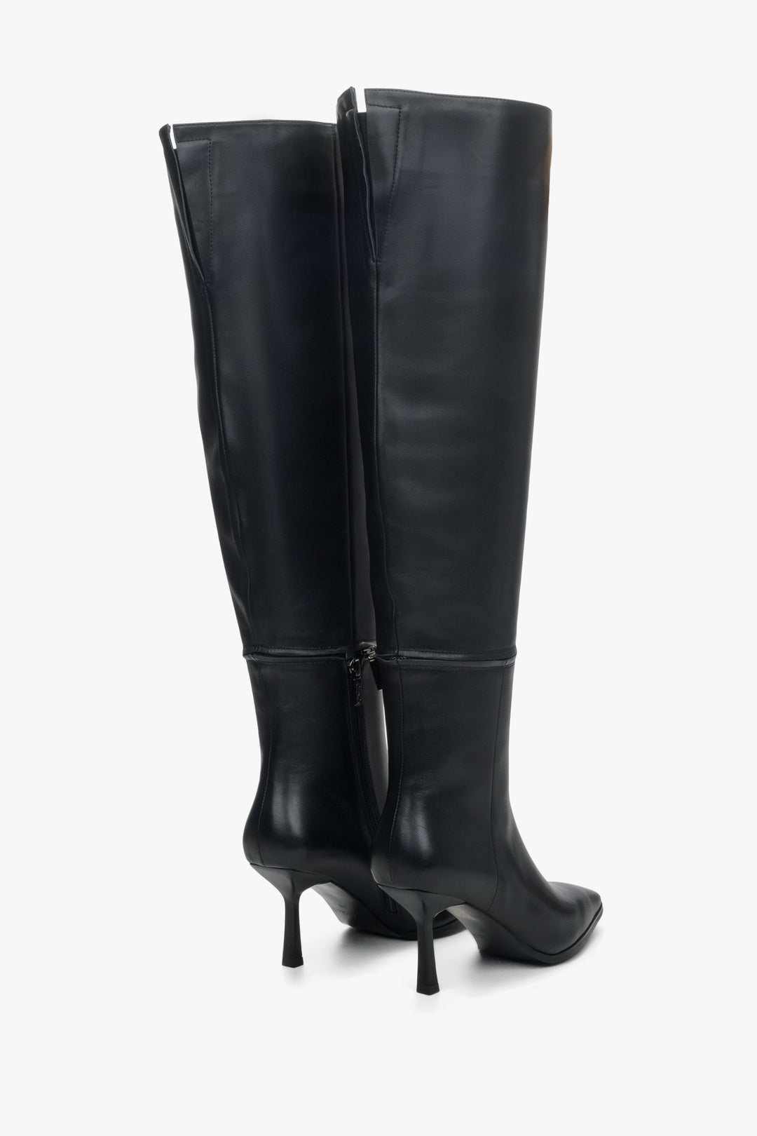 Women's black leather unfastened boots by Estro - close-up on the heel and side stripe of the shoes.