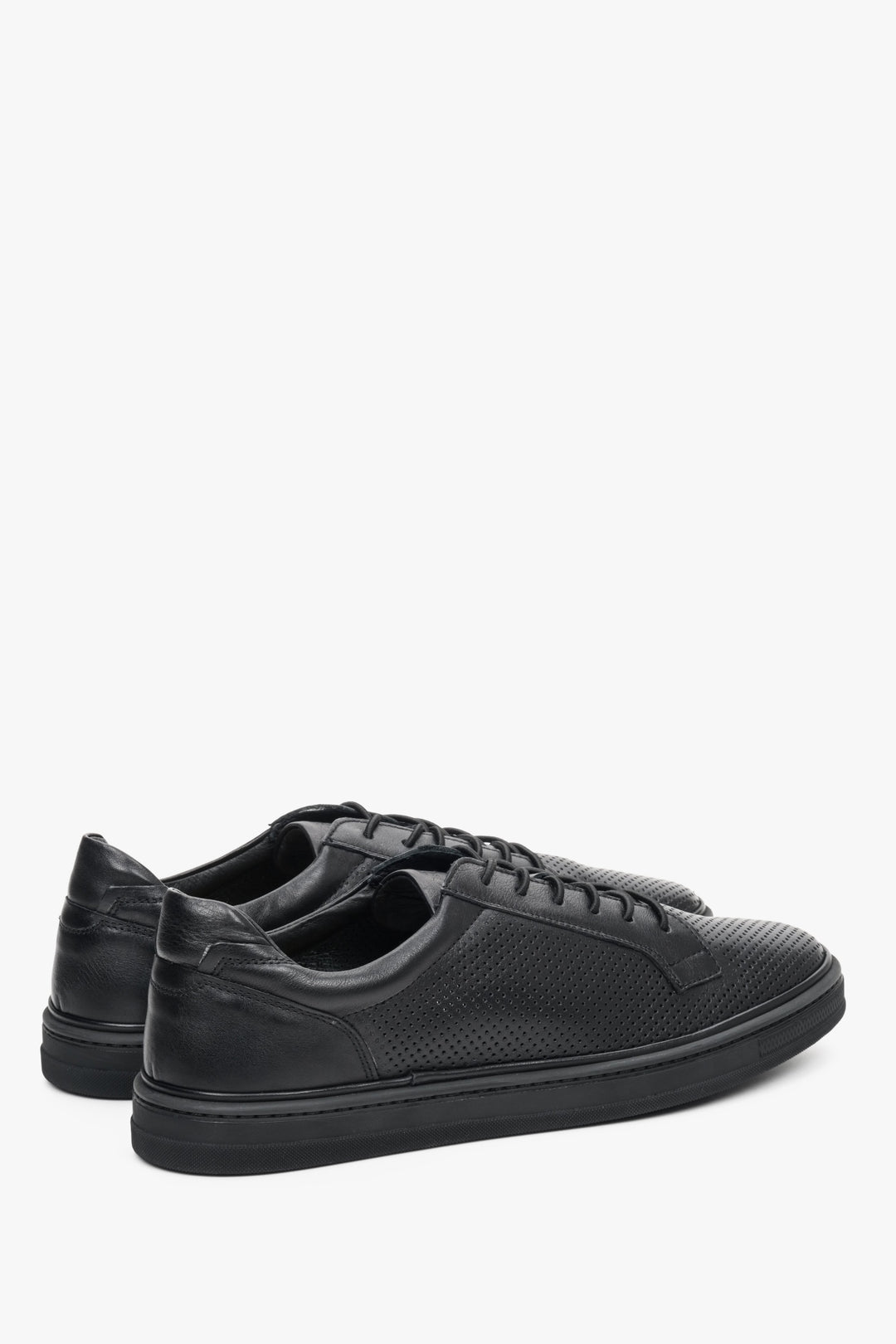 Black men's natural leather sneakers for summer with perforations - close-up on the sideline of the shoe.
