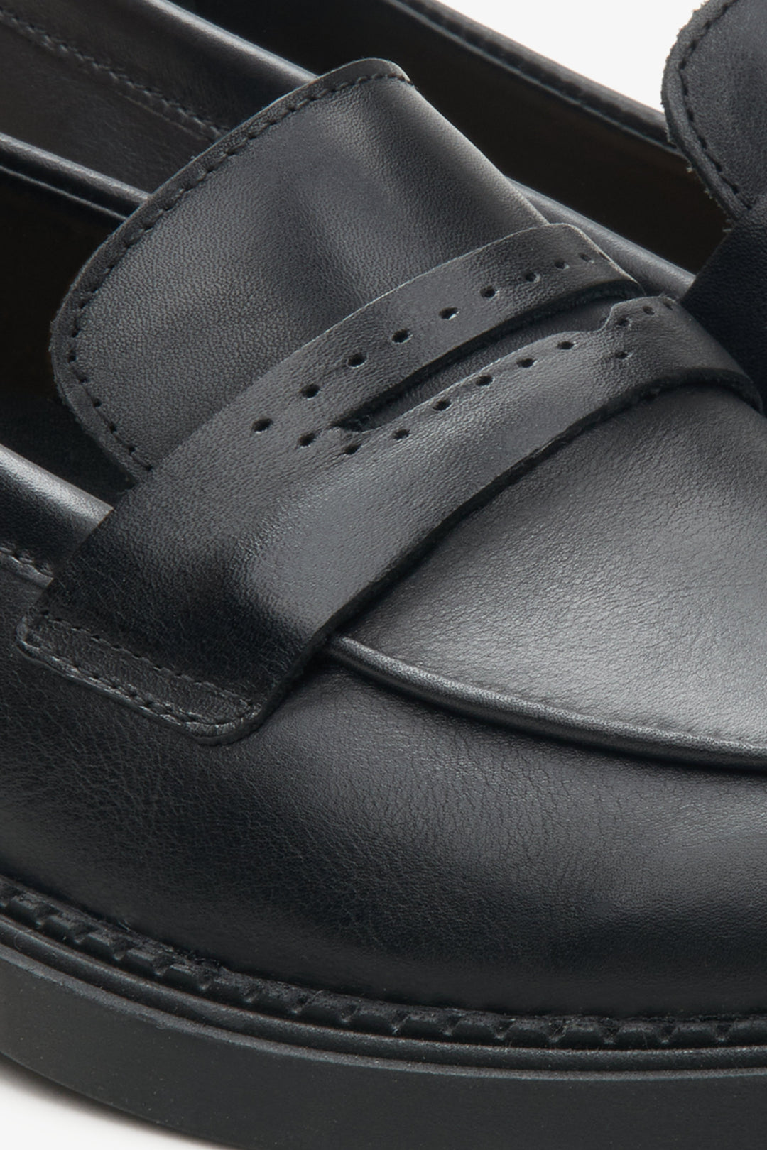 Women's black loafers made of genuine leather - close-up on the details.
