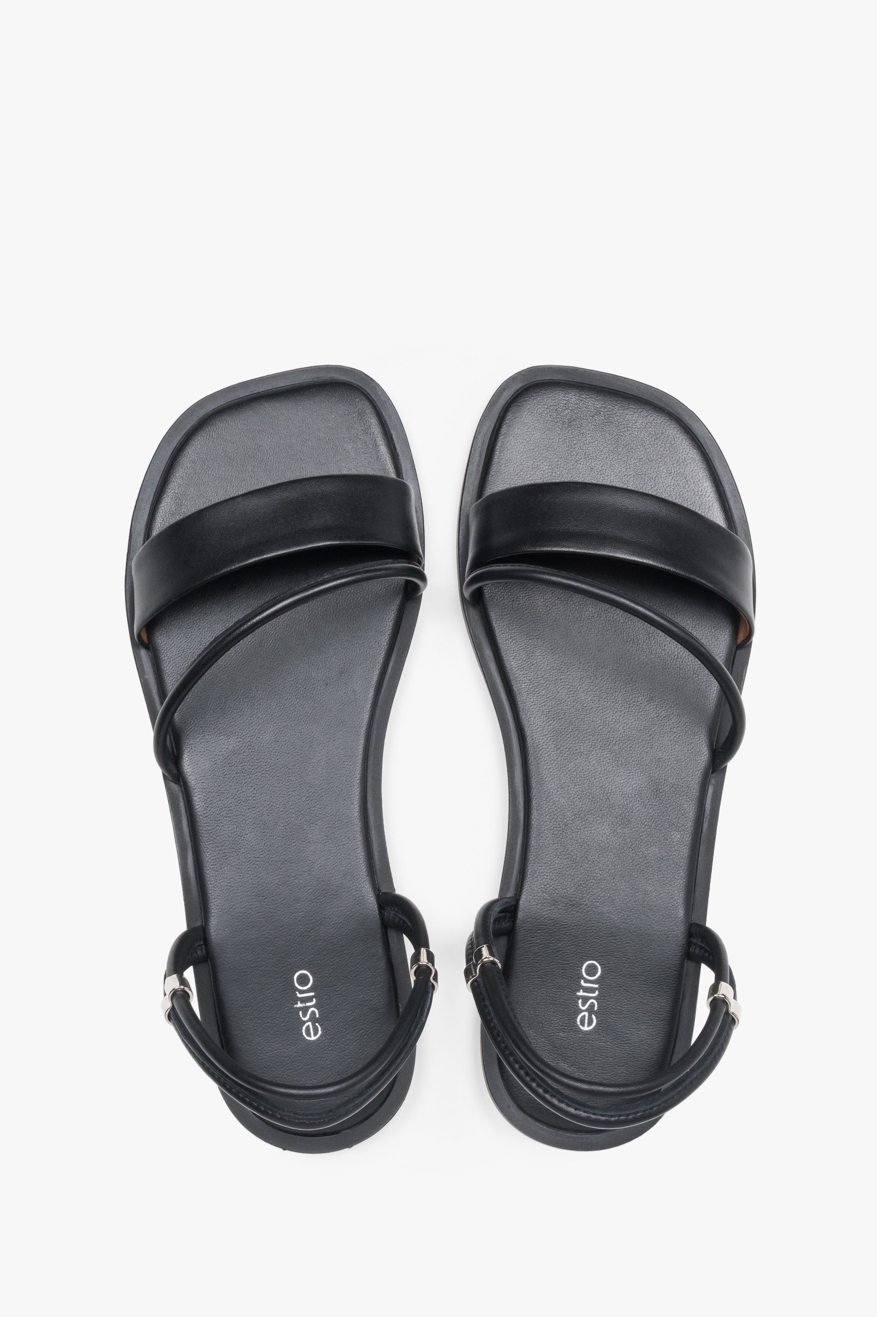 Women’s lightweight black sandals with thin straps made of genuine leather by Estro – top view.