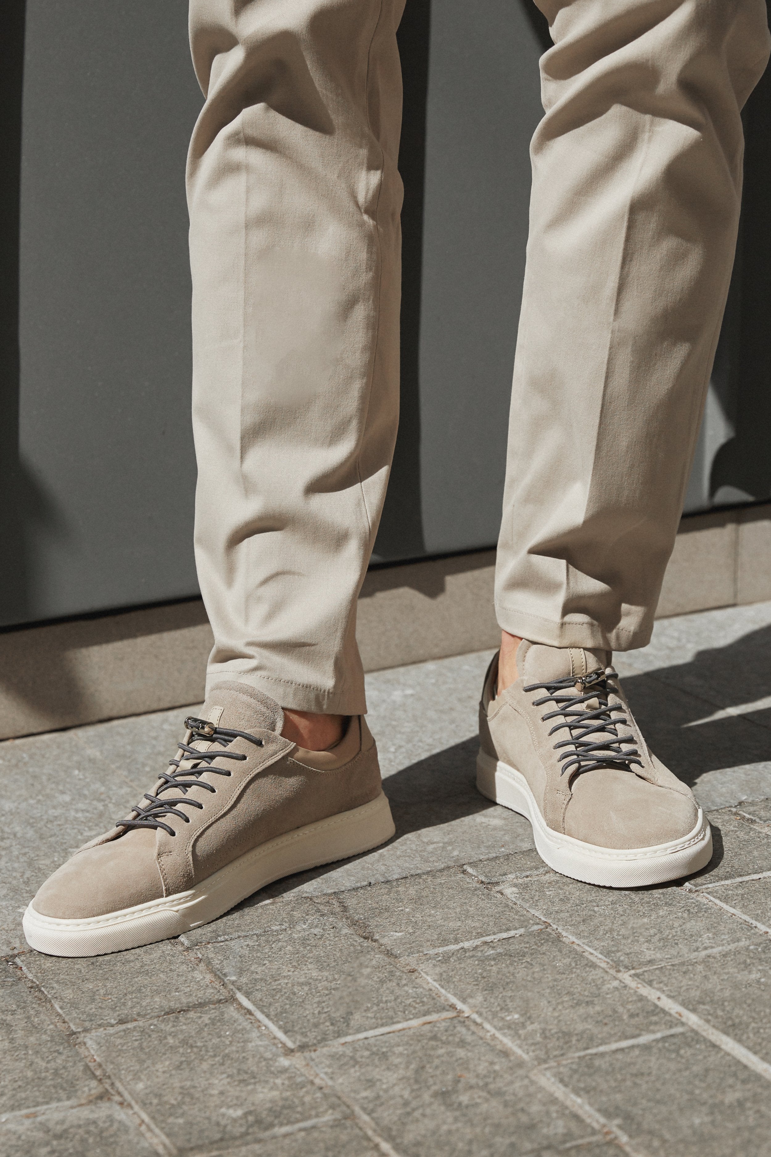 Grey suede men's sneakers for spring/fall - presentation on a model.