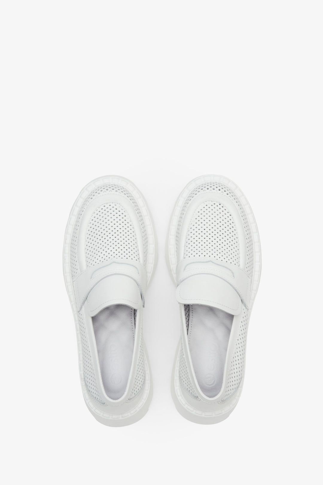 Women's leather loafers with perforation in white color - shoe presentation from above.