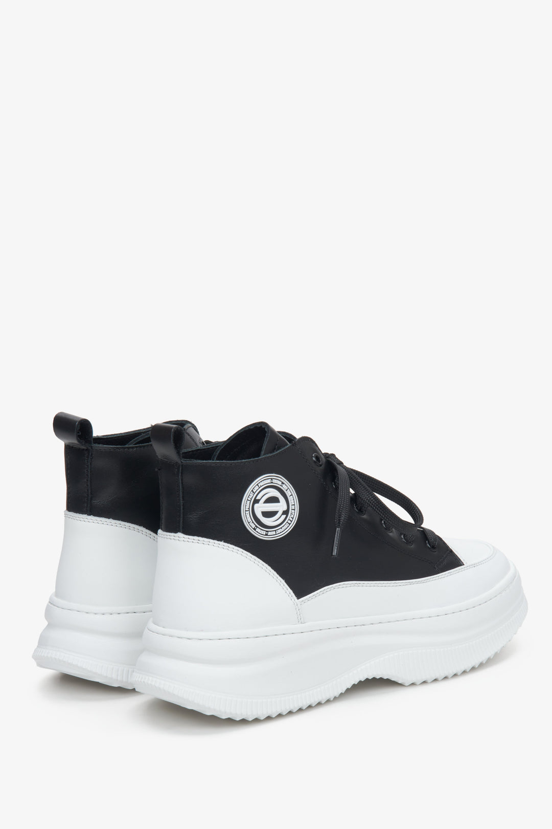 Women's black and white natural leather sneakers.